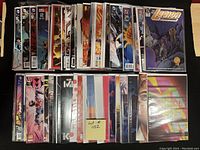 Photo showing all 50 high grade comics arranged in two rows, clearly bagged and boarded for protection