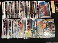 Photo showing 50 individual bagged and boarded comic books spanning multiple popular superhero and fantasy titles.