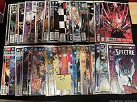 Photo showing 50 comic books bagged and boarded including titles from DC Comics and Marvel such as The Spectre, Teen Titans, Justice League, Avengers, Batman, and more.