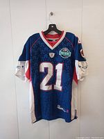 Front view of blue All-Star football jersey with large number 21 and Pro Bowl chest patch, showing red and white accents.