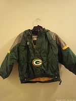 Front view of Green Bay Packers jacket showing large team logo on front and color details.