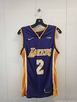 Front view of Lonzo Ball Los Angeles Lakers basketball jersey in purple with gold and white accents, featuring number 2 and Nike and Wish logos.