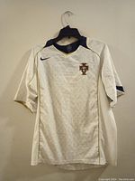 Front view of white Portugal soccer jersey, Nike branded, with Portugal crest on chest, size large.