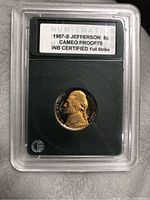 1987-S Jefferson 5 cent coin in protective slab with certification label
