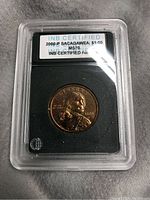 The 2000-P Sacagawea $1.00 coin encapsulated in a protective slab with grading label visible.