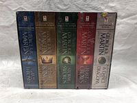Front view of the boxed set showing the spines of all five books in shrink wrap.