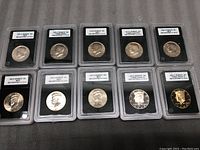 Lot of 10 Kennedy half-dollar coins in certification holders, showing obverse side with various years and mint marks and certification labels.