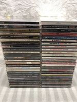 Photo showing front view stack of 50 Hip Hop, Soul, and R&B music CDs showing spine titles including Mary J. Blige, Blackstreet, TLC, Boyz II Men.