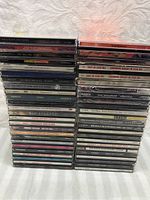 Photo showing stacks of 50 music CDs including various artists and titles