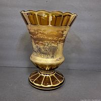 Front view of the amber-tinted Moser crystal vase showing the horse-drawn carriage scene with gold detailing.