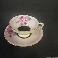 Photo of Paragon cup and saucer showing pink rose floral design and gold trim, no visible damage