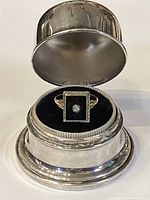 Front view of ring displayed in open silver plated ring box
