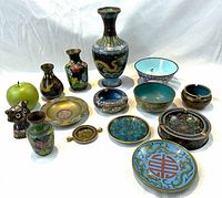 Front overview of collection showing all 14 cloisonne and enamel items including vases, bowls, ashtrays, trays and figurine