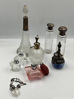 Group shot of all nine perfume bottles on white background.