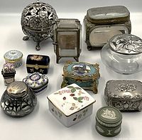 Front view of all thirteen lidded boxes arranged in rows