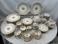 Full set of Queen Anne bone china pieces arranged on table