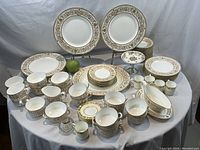 Overview of entire dishware collection on cloth-covered table