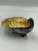 Side angle showing shell profile and gilt interior