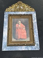 Full frontal photo of the framed watercolor against black background