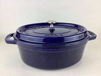 Front view of blue Staub oval cocotte with lid