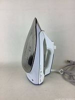 Side view of the Rowenta steam iron showing the stainless steel soleplate and ergonomic white handle with controls.