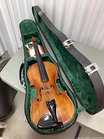 Top view of violin and open case showing instrument and accessories