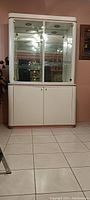 Front view of white china cabinet with glass doors and lower storage
