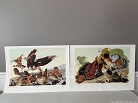 Pair of John James Audubon lithographs side by side on a gray wall showing bird scenes
