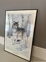 Framed Al Agnew print of a wolf in snowy forest setting, showing full artwork and frame.