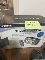 Garmin StreetPilot 2730 box showing product branding and features including XM satellite radio and traffic, and DVD included.