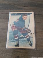 Front of 1953-54 Parkhurst Ed Kullman hockey card showing player in Rangers uniform skating with stick.