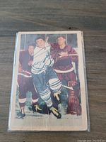 Front of the card showing Ron Stewart mid-action in a vintage hockey scene with visible wear and creases.