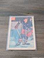 Front side of the 1954-55 Parkhurst Don Raleigh hockey card showing the player skating in New York Rangers gear with card number 68 visible.
