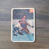 Front of the 1954-55 Parkhurst hockey card showing player Jacques Plante in action near the goal, card number 99 visible at upper right.