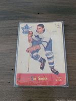Front of 1955-56 Parkhurst Sid Smith hockey card showing player in Toronto Maple Leafs uniform, with name and position visible. Card shows wear and aging.