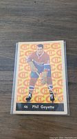 Front side of the 1961-62 Phil Goyette Parkhurst hockey card showing player image and team logo background