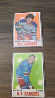 Front of Walter Tkaczuk and Bob Nevin NHL hockey cards in Rangers jerseys with colorful backgrounds.
