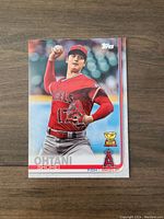 Front of the Shohei Ohtani rookie card showing him pitching in Angels uniform, with Topps and Rookie Cup logos visible.
