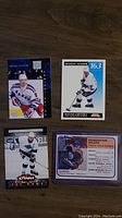 Four Wayne Gretzky hockey cards laid out showing front sides with player images and card designs.