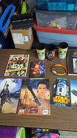 All Star Wars items displayed, including figure, cups, magazines, cards, and posters.