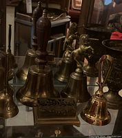All items arranged on glass shelf showing full set of bells, goblets and trinket box