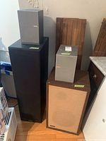 Five speakers arranged: two Advent wood-veneer, tall black DF Mach 3, two Sony SS-CJ3MDX on top