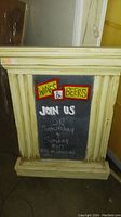 Front view of heavy chalk board with Greek style cream wooden frame, featuring 'Wines & Beers' signs and chalk writing