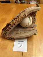 Baseball glove open showing interior and baseball inside