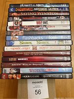 Top view photo showing DVD spines with titles of 14 DVDs included in the lot.