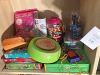 Overview photo showing multiple kids arts and crafts items including the kids pottery wheel, craft kits, and containers of craft supplies