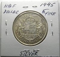 Front side of the 1945 Canadian 50 cents silver coin in white cardboard holder with handwritten notes 'HALF DOLLAR', '1945', 'FINE', and 'SILVER'.