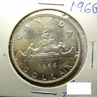 Obverse side showing the canoe with two men paddling and '1966' date, 'CANADA' and 'DOLLAR' inscriptions.