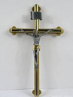 Full view of brass crucifix with gold cross and silver corpus with gold accents.