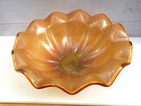 Top view of the large vintage Murano glass bowl showing amber color and wavy edges.